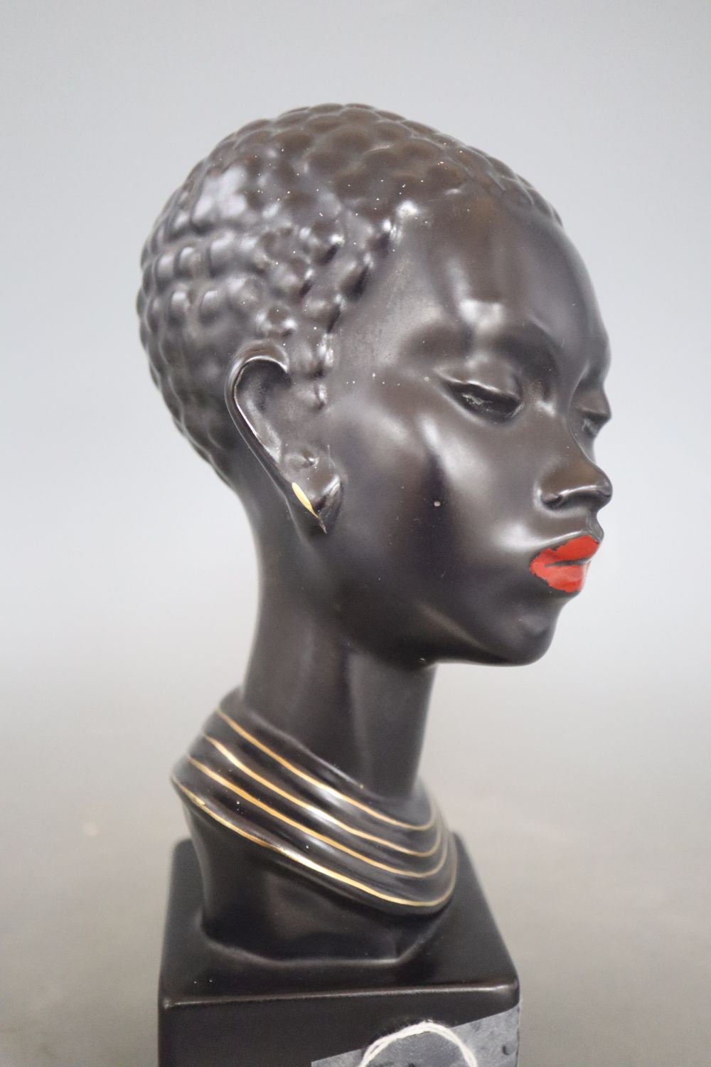 A 1960s ceramic bust of a tribal woman, signed, height 22cm